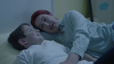 Image of cheerful mother lying in bed with little son. Stock Footage 198375817