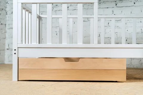 The image of the child's bed, bottom view of the storage drawers. An unpainted 스톡 사진