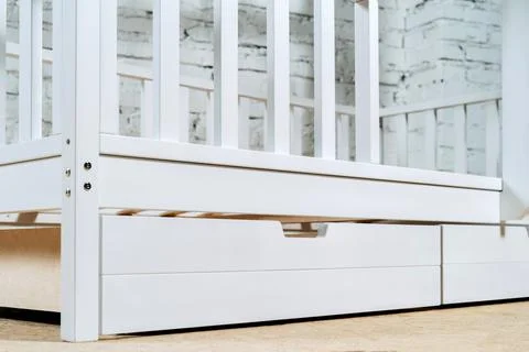 The image of the child's bed, bottom view of the storage drawers. White Stock Photos