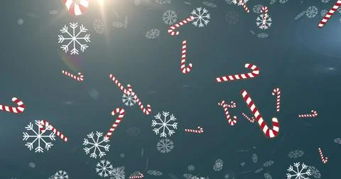 Image of christmas candy canes decorations and snow falling on blue background Stock Illustration