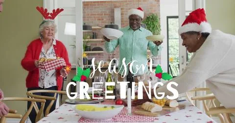 Image of christmas greetings text over senior diverse friends at christmas meal Ilustração Stock