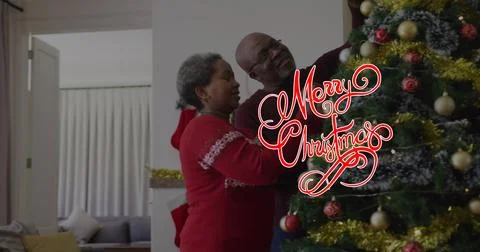 Image of christmas greetings text over african american couple decorating Ilustração Stock