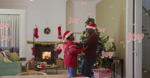 Image of christmas greetings text over african american couple dancing at Stock Illustration