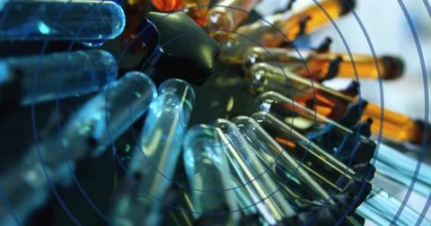Image of circles moving over test tubes 写真素材