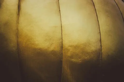 The image is a close up of a gold object with a shiny surface Stock Photos