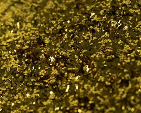 Image of a close-up pile of hexagonal gold glitter flake. Stock Photos