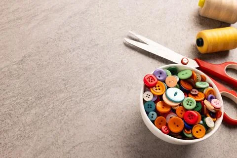 Image of close up of scissors, buttons and threads and copy space on cream 写真素材