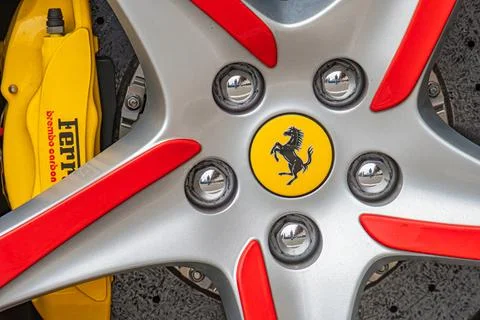 Image of a close-up view of a shiny silver Ferrari wheel with red accents and Stock Photos