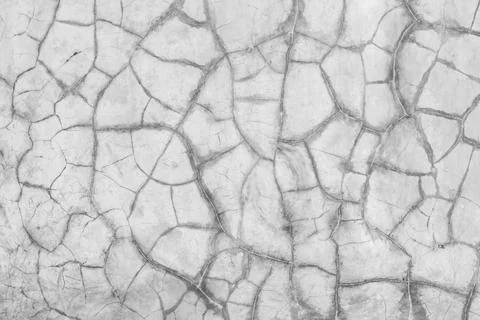 The image is a close up of a wall with cracks and holes in it Stock Photos