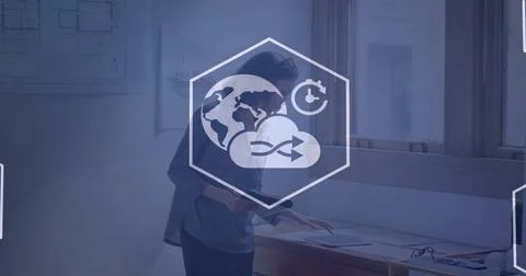 Image of cloud and network of icons over biracial businesswoman in office 스톡 사진