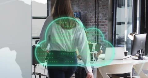 Image of cloud icon and data processing over diverse businesswomen in office Stock Photos