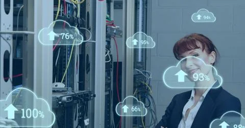Image of cloud icons with growing numbers over caucasian woman in server room Stockfoto's