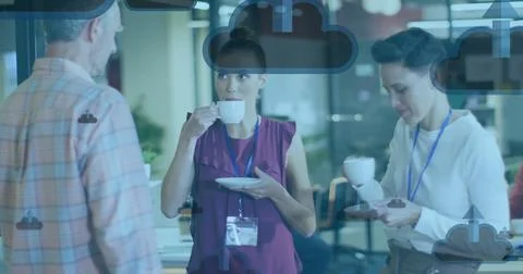 Image of clouds with arrows icons over diverse colleagues talking in office Stock Photos