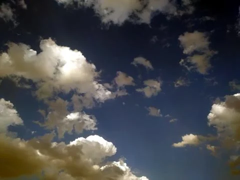 This is the image of clouds they are flying in the sky with sun rays Stock Photos