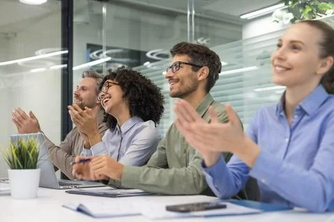Image of colleagues clapping hands at seminar, listening speaker. Business ed Stock Photos