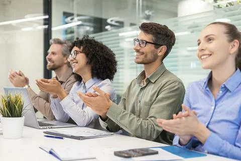 Image of colleagues clapping hands at seminar, listening speaker. Business ed Stock Photos