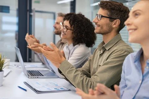 Image of colleagues clapping hands at seminar, listening speaker. Stock Photos