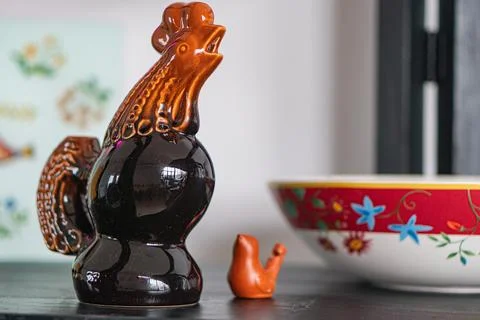 Image of a collection of ceramic objects, including a dark-colored chicken .. Stock Photos