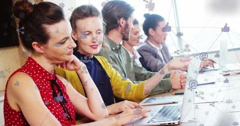 Image of computer icons connected with lines over diverse coworkers using t.. Stock Photos