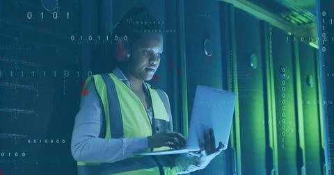 Image of computer language, african american female engineer using laptop in Stock Photos