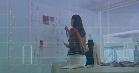 Image of computer language and graph on biracial female designer checking d.. 库存照片