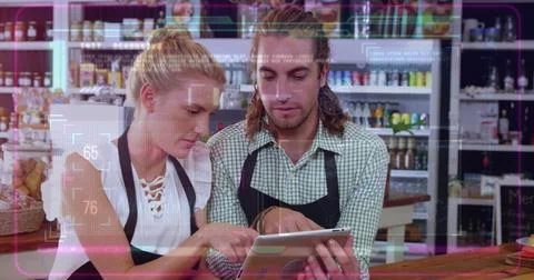 Image of computer language over caucasian coworkers using digital tablet in cafe Stock Photos