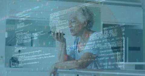 Image of computer language over senior biracial woman talking on speaker of 스톡 사진