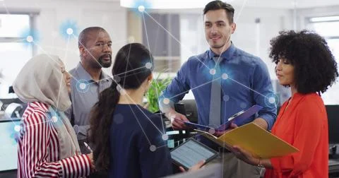 Image of connections and data processing over diverse business people in office Foto stock