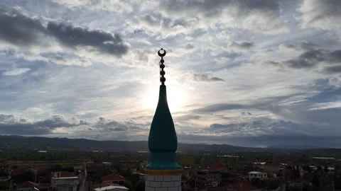 Image of the crescent representing Islam on the mosque minaret on a cloudy day Stock Footage 256573337