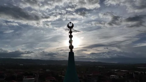 Image of the crescent representing Islam on the mosque minaret on a cloudy day Stock Footage 256573352