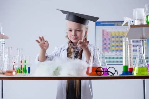Image of cute chemist conducting experiment in lab Stock Photos