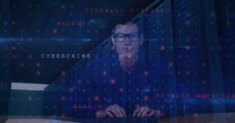 Image of cyber attack warning and data processing over male hacker and computer Stock Photos