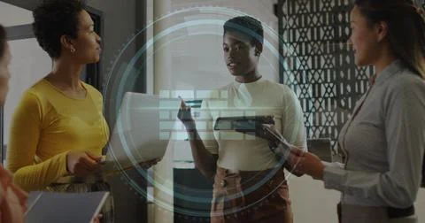 Image of cyber security text and firewall icon over diverse women discussing Stock Photos
