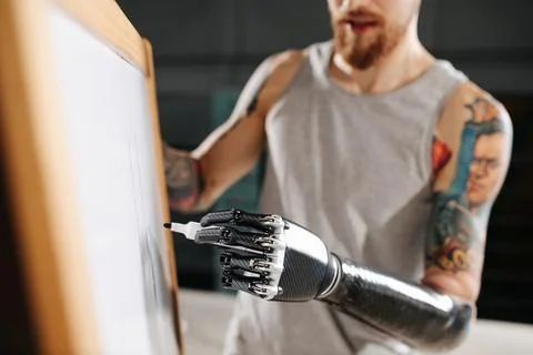 Image of a cyborg man with bionic hand writing on a board with permanent marker Stock Photos