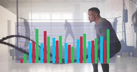 Image of data processing and diagrams over biracial man exercising with ropes at Stock Photos