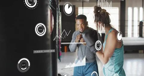 Image of data processing and diagrams over biracial couple boxing at gym Fotos Stock