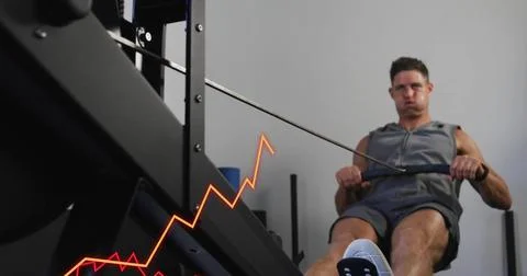 Image of data processing and diagrams over caucasian man using rowing machine at Foto stock
