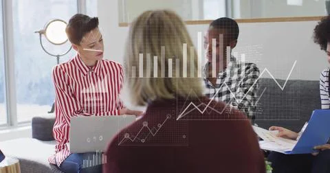 Image of data processing and diagrams over diverse colleagues discussing work in Stockfoto's