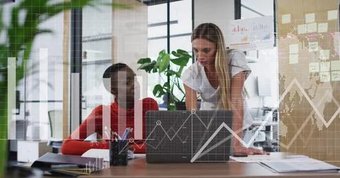 Image of data processing and diagrams over diverse female colleagues discussing Stockfoto's