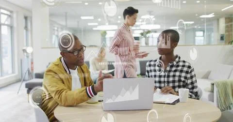 Image of data processing and diagrams over diverse colleagues discussing work in Stockfoto's