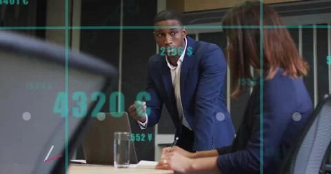 Image of data processing and diagrams over diverse colleagues discussing work in Stockfoto's