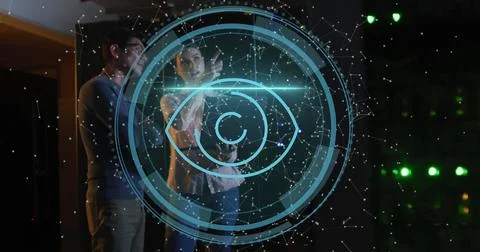 Image of data processing and eye icon over diverse workers in server room Stock Photos