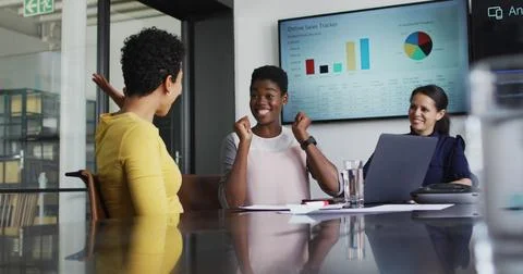 Image of data processing and globe over diverse business people high fiving in Stock Photos