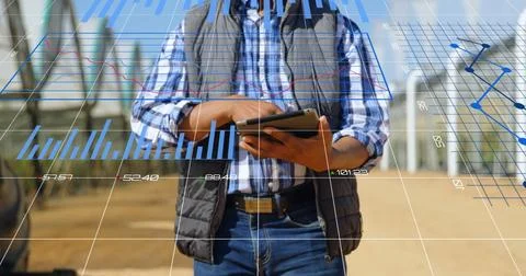Image of data processing and statistics over biracial engineer using tablet Stock Photos