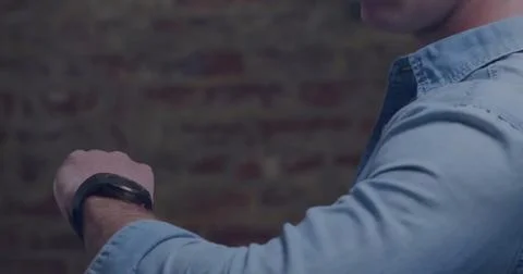 Image of data processing and stock market over caucasian man using smartwatch Stock Photos