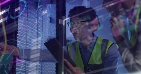 Image of data processing, diverse male and female it engineers with tablet by Stock Photos
