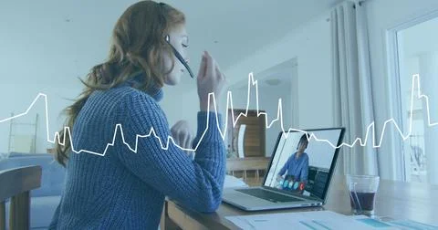 Image of data processing on graph over caucasian woman at home making laptop Stock Photos