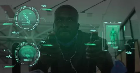 Image of data processing over african american man on stationary bike in gym Stock Photos