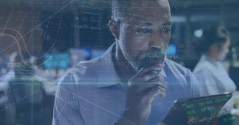 Image of data processing over african american businessman using tablet 写真素材