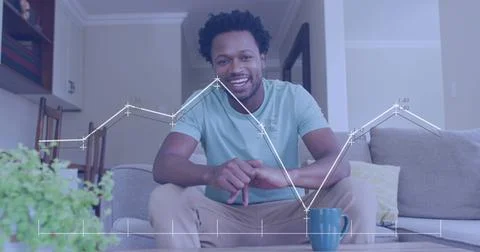 Image of data processing over african american man smiling and talking looking Foto stock